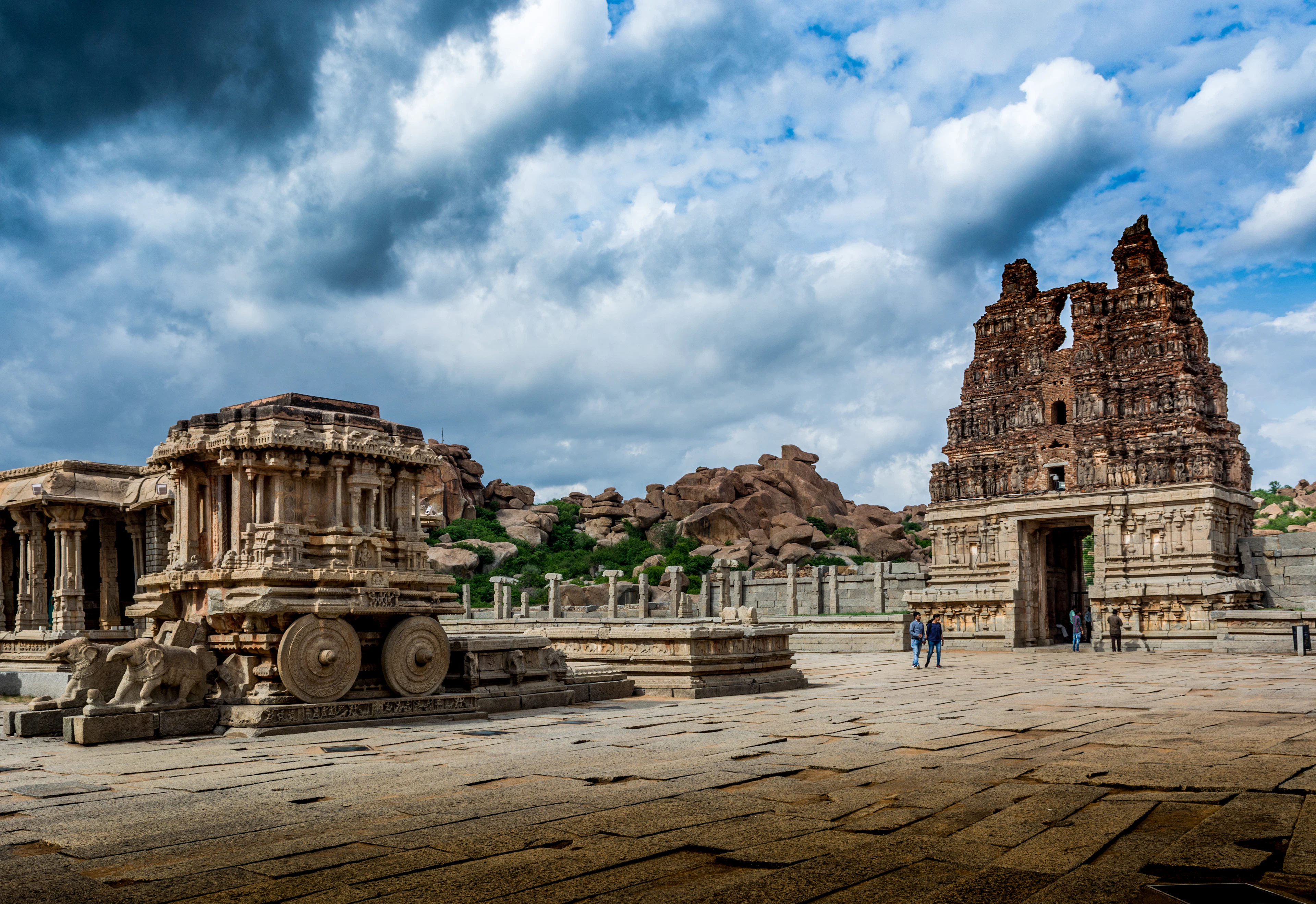 Stone structures scattered across the Hampi landscape