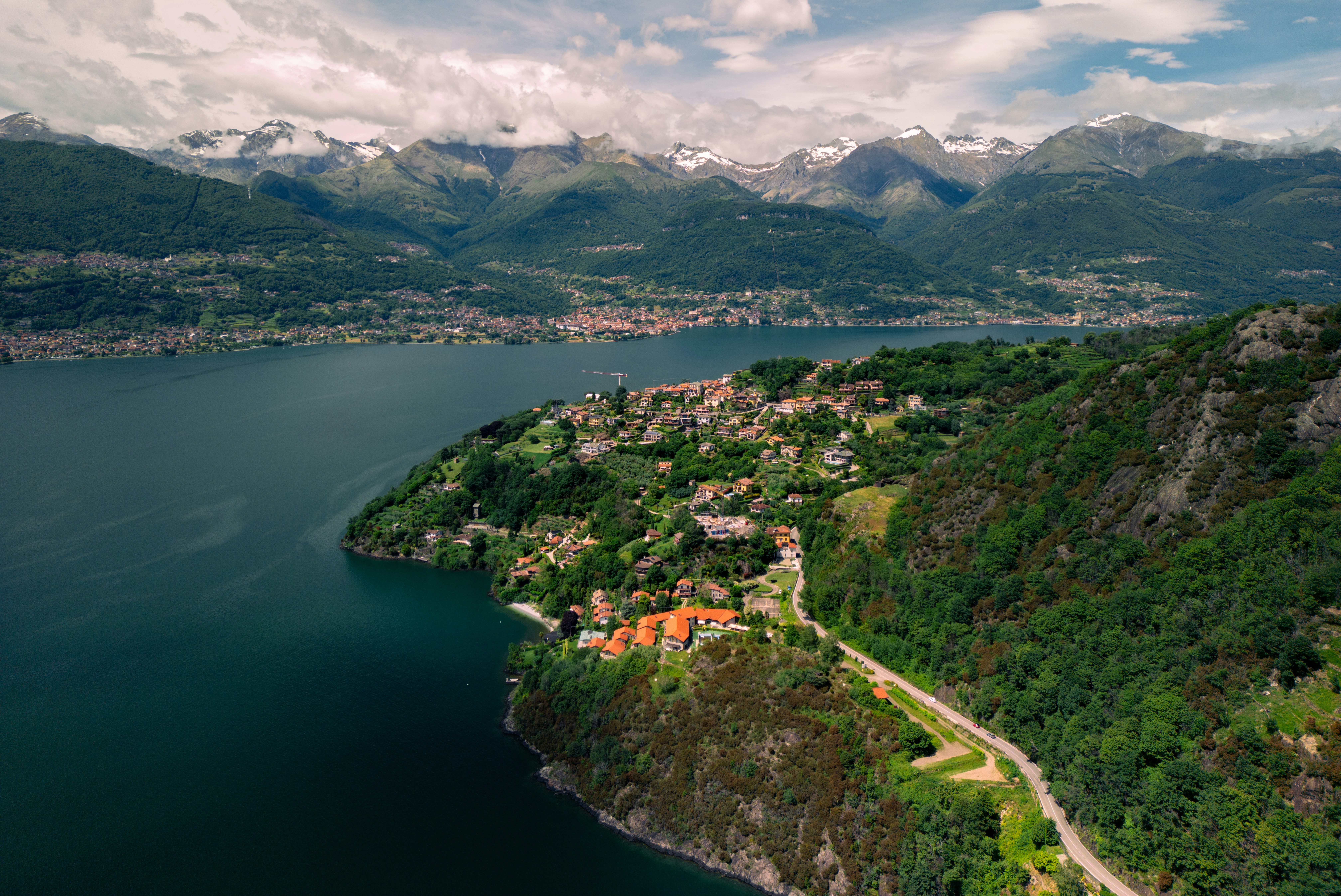 A scenic view of a lake and mountains, Lake Como as captured by a drone flying above Dorio, Province of Lecco, Lake Como, Italy.