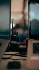 Two laptops and a cell phone on a desk