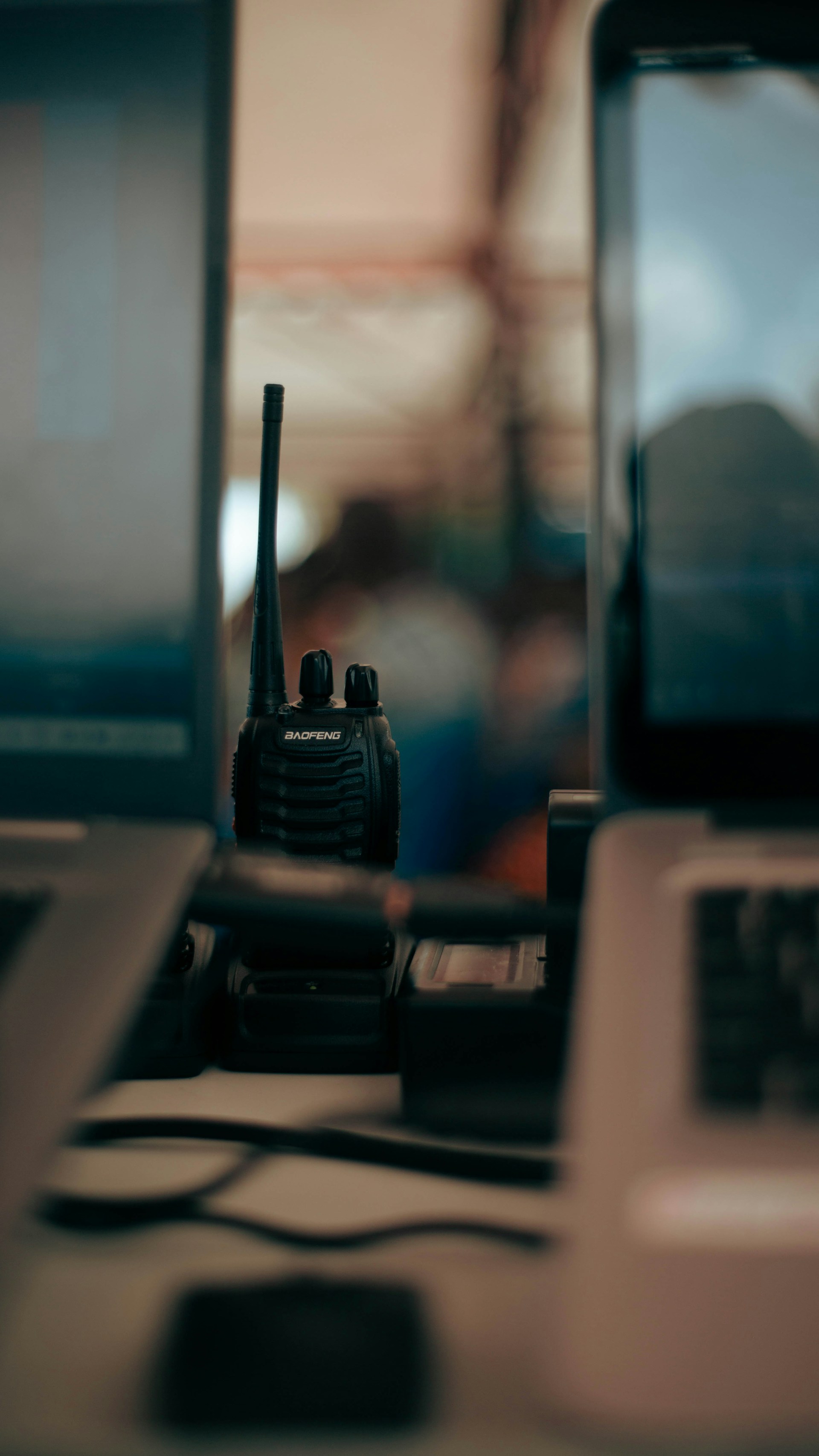 Two laptops and a cell phone on a desk