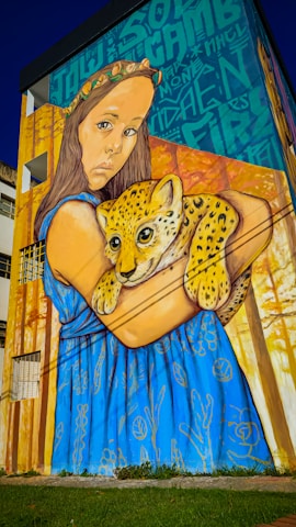 A painting of a woman holding a baby cheetah