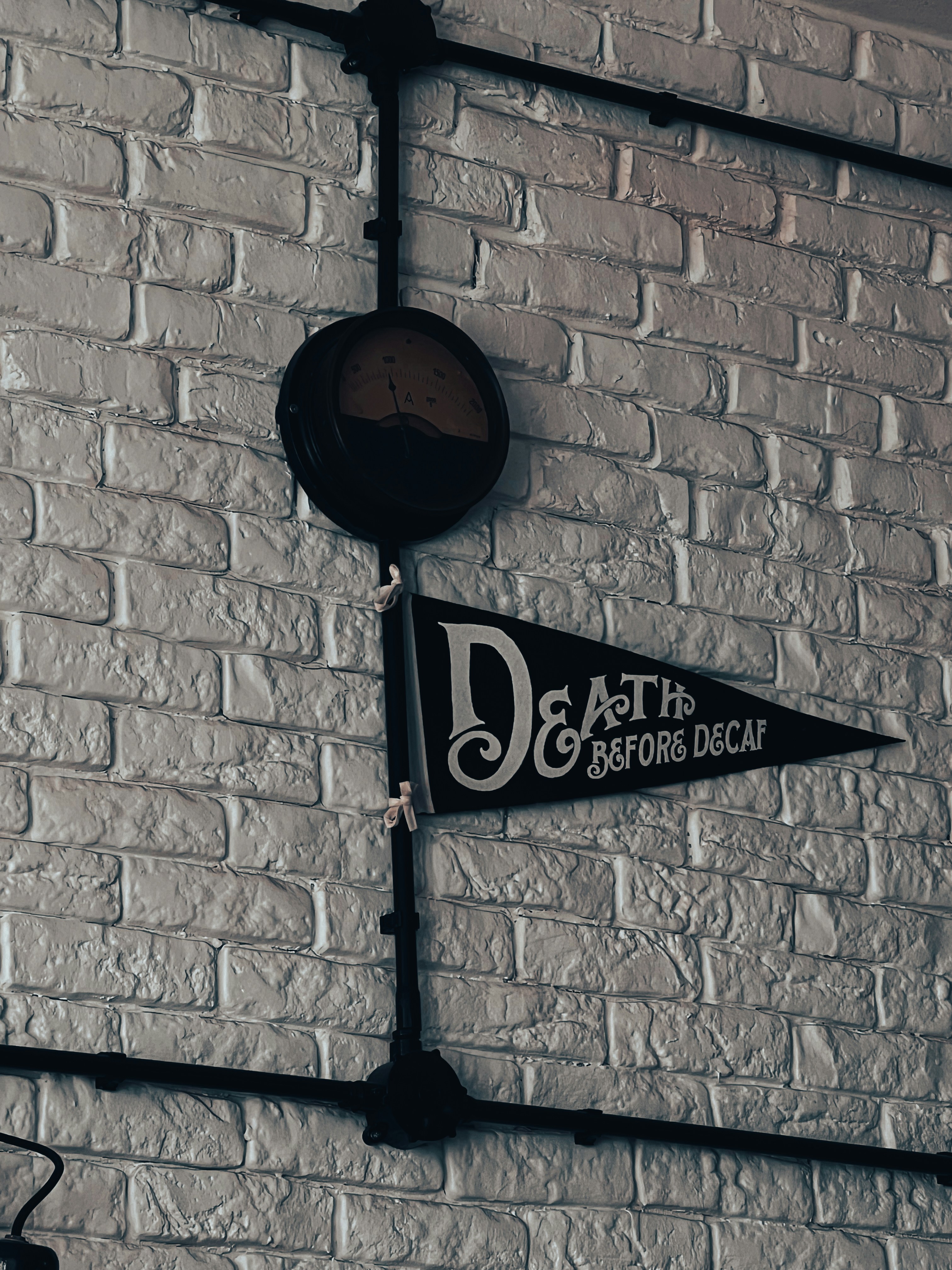 A brick wall with a clock and sign on it