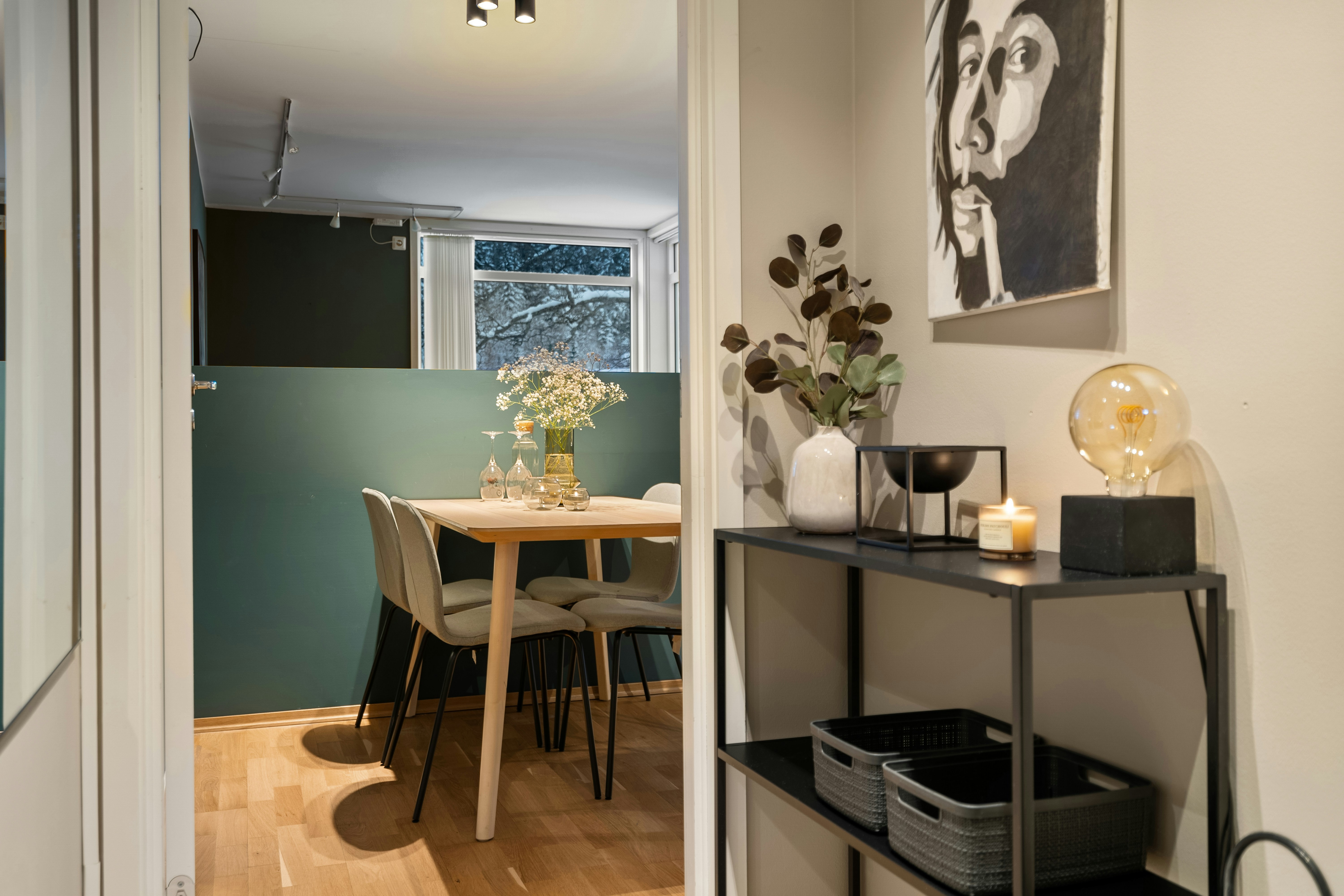 A room with a table, chairs, and pictures on the wall