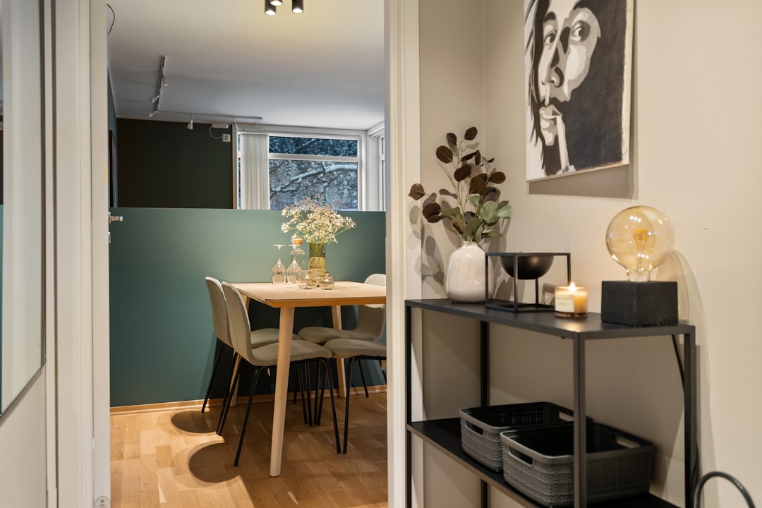 A room with a table, chairs, and pictures on the wall