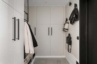 A white hallway with black and white accessories