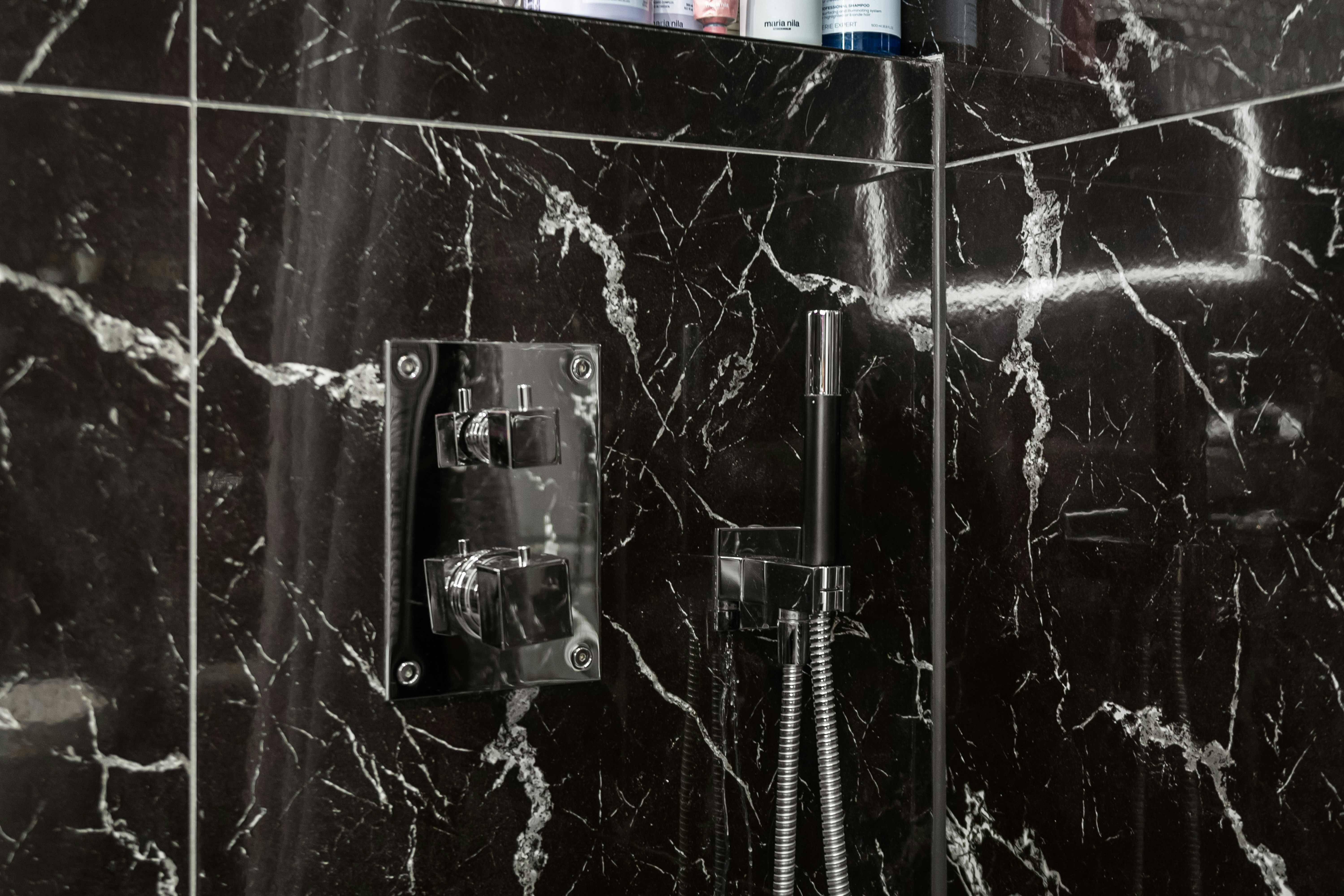 Seamless microcement bathroom walls with modern fixtures showing premium finish without grout lines