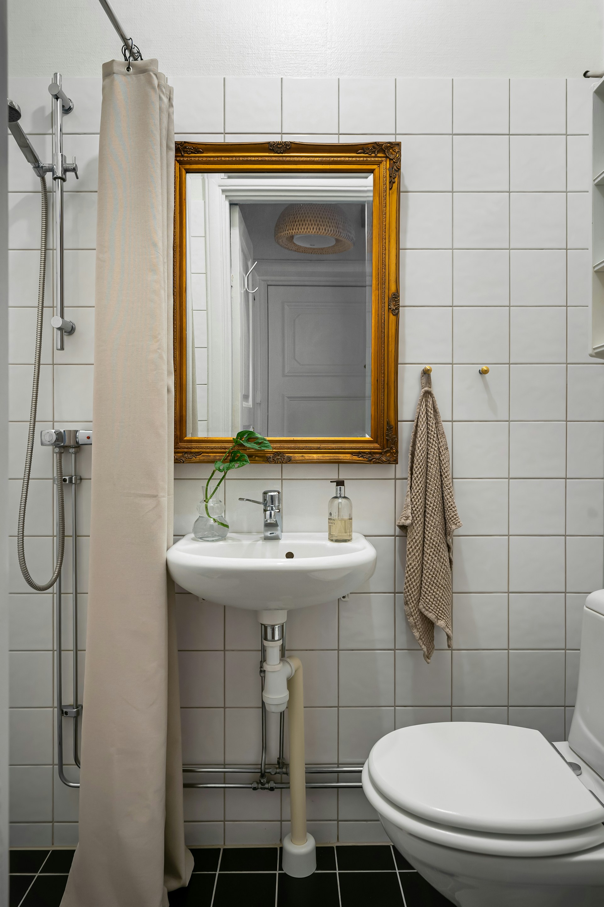 A bathroom with a sink, toilet, and shower