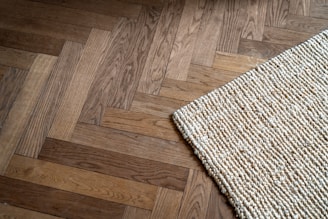 A close up of a rug on a wooden floor