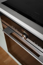 A close up of a stove with a microwave on top of it