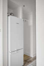 A white refrigerator freezer sitting inside of a kitchen