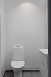 A white toilet sitting in a bathroom next to a sink