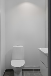 A white toilet sitting in a bathroom next to a sink