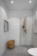 A bathroom with a shower, toilet and sink