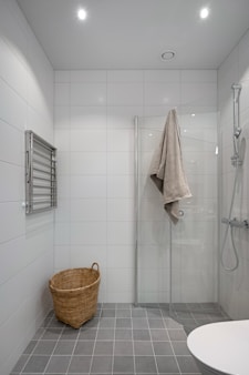 A bathroom with a shower, toilet and sink