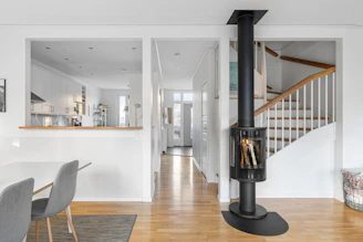 A living room with a fire place in the middle of it