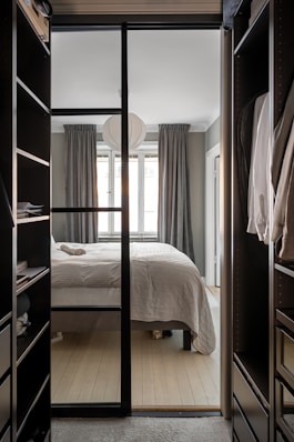 A bedroom with a bed and a closet