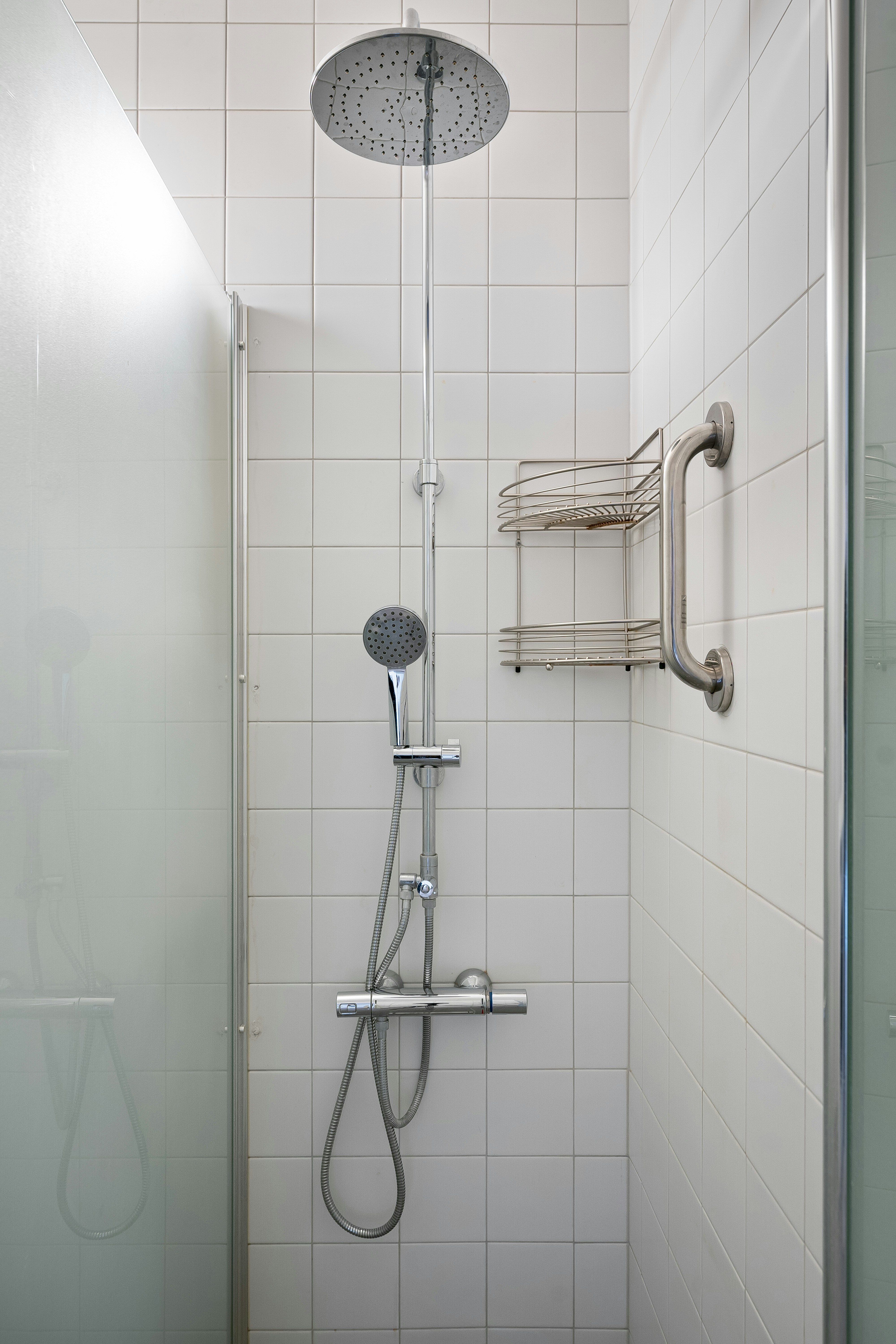 A walk in shower sitting next to a shower head