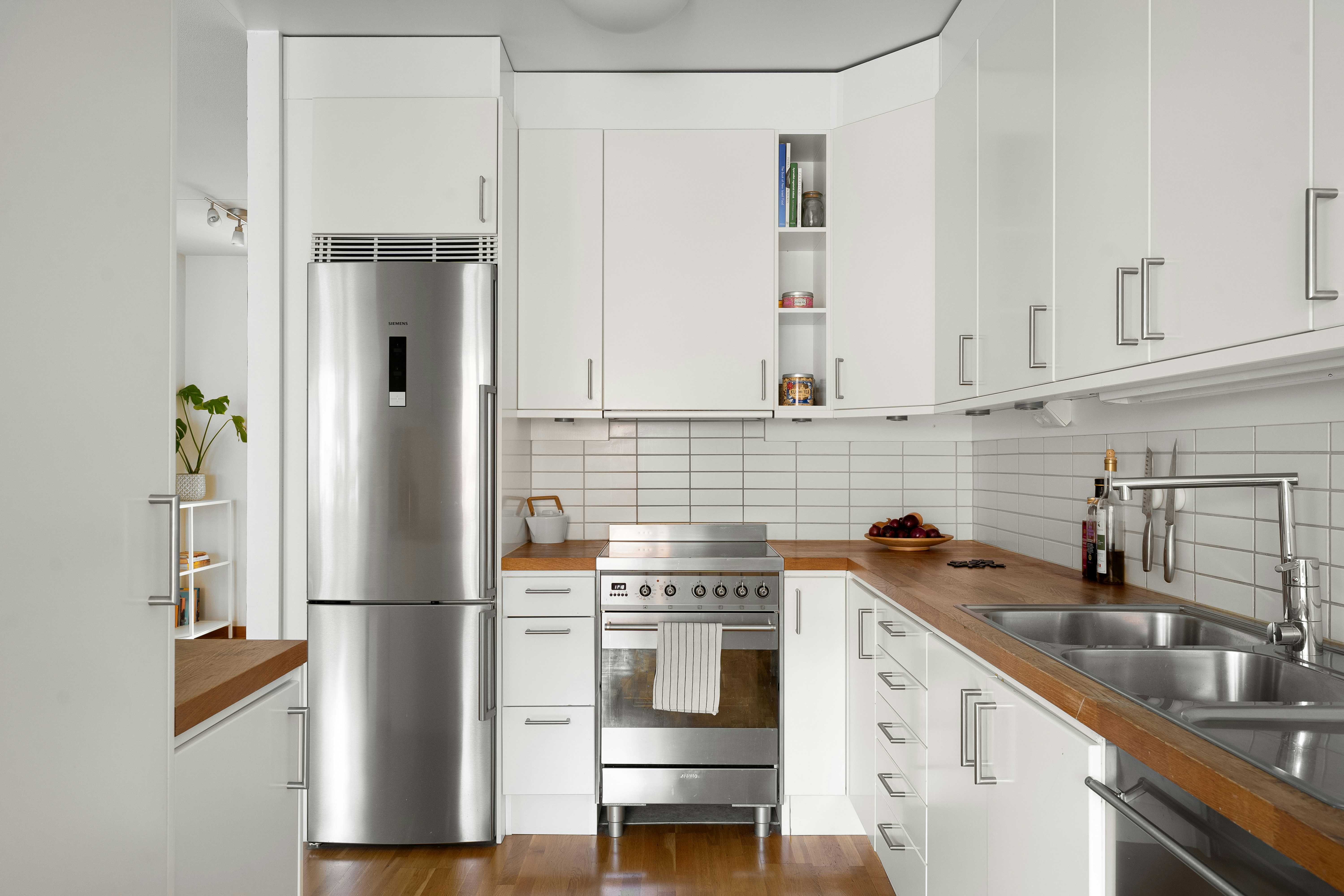 kitchen with compact, stainless steel appliances neatly integrated into the cabinetry - small kitchen 8 by 10 kitchen layout