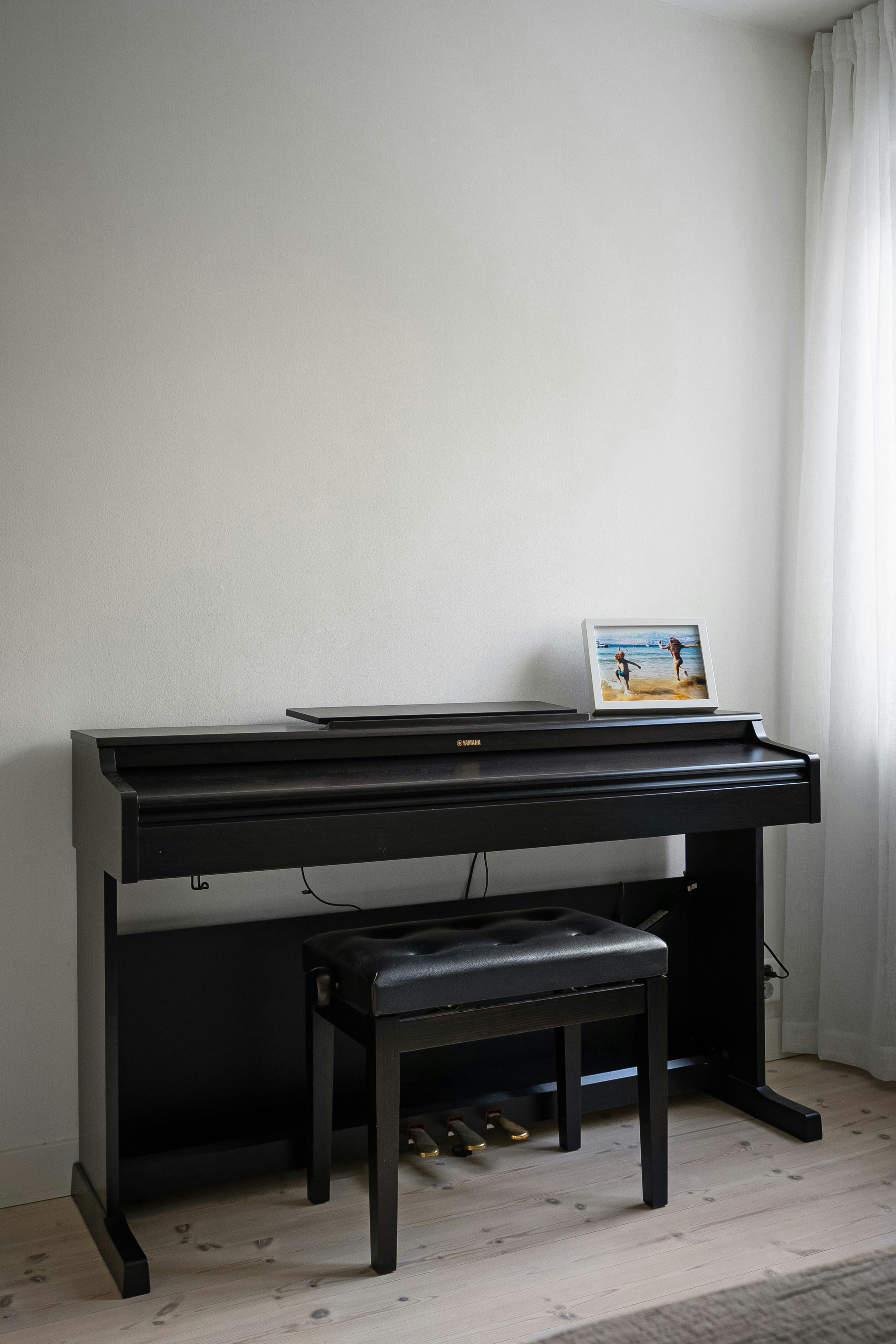 A piano sitting in front of a window
