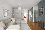 A living room filled with furniture and a hard wood floor