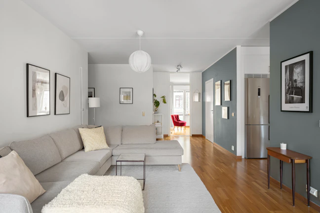 A living room filled with furniture and a hard wood floor
