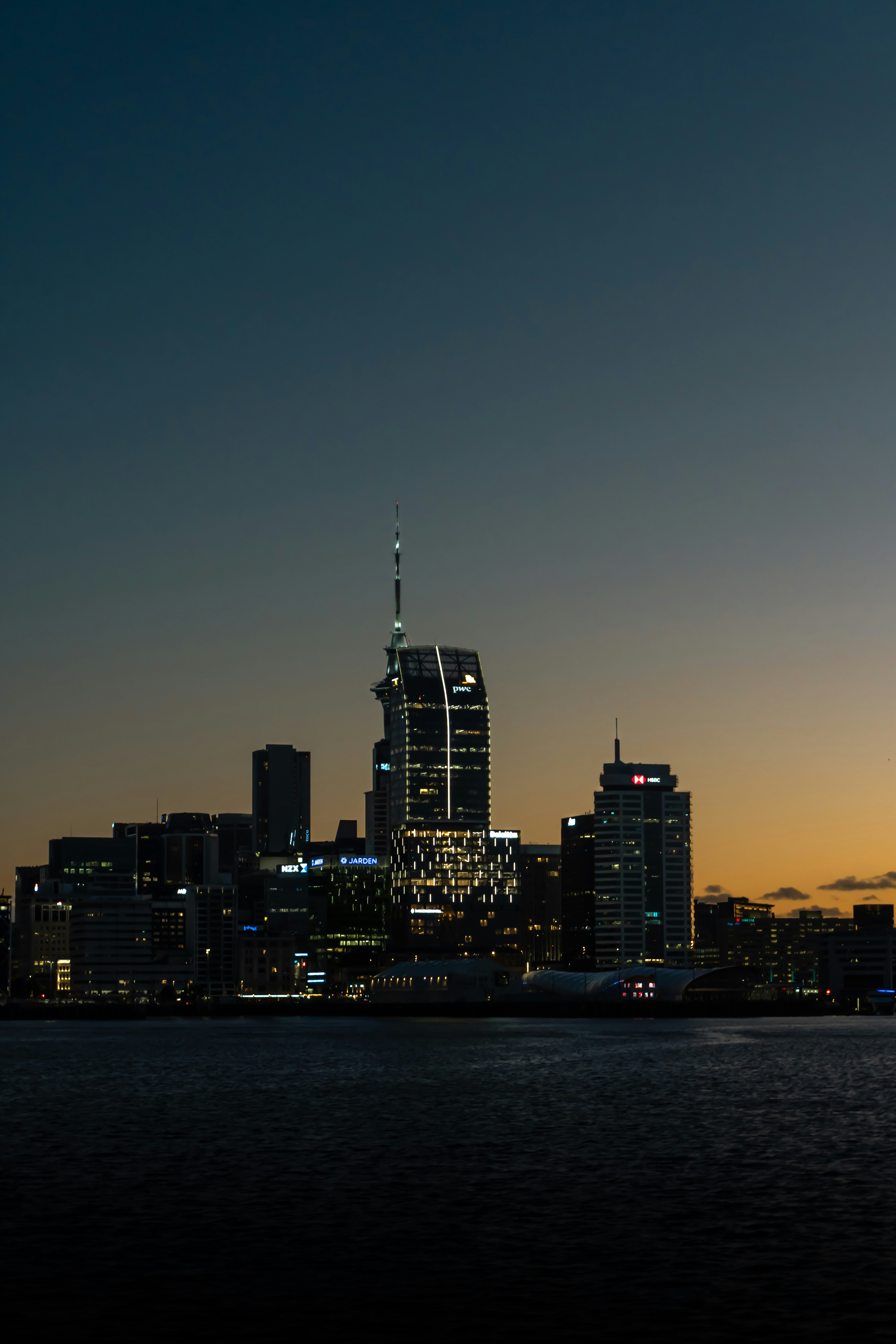 A view of a city at night from the water