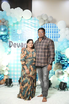 A man and a woman standing in front of a backdrop