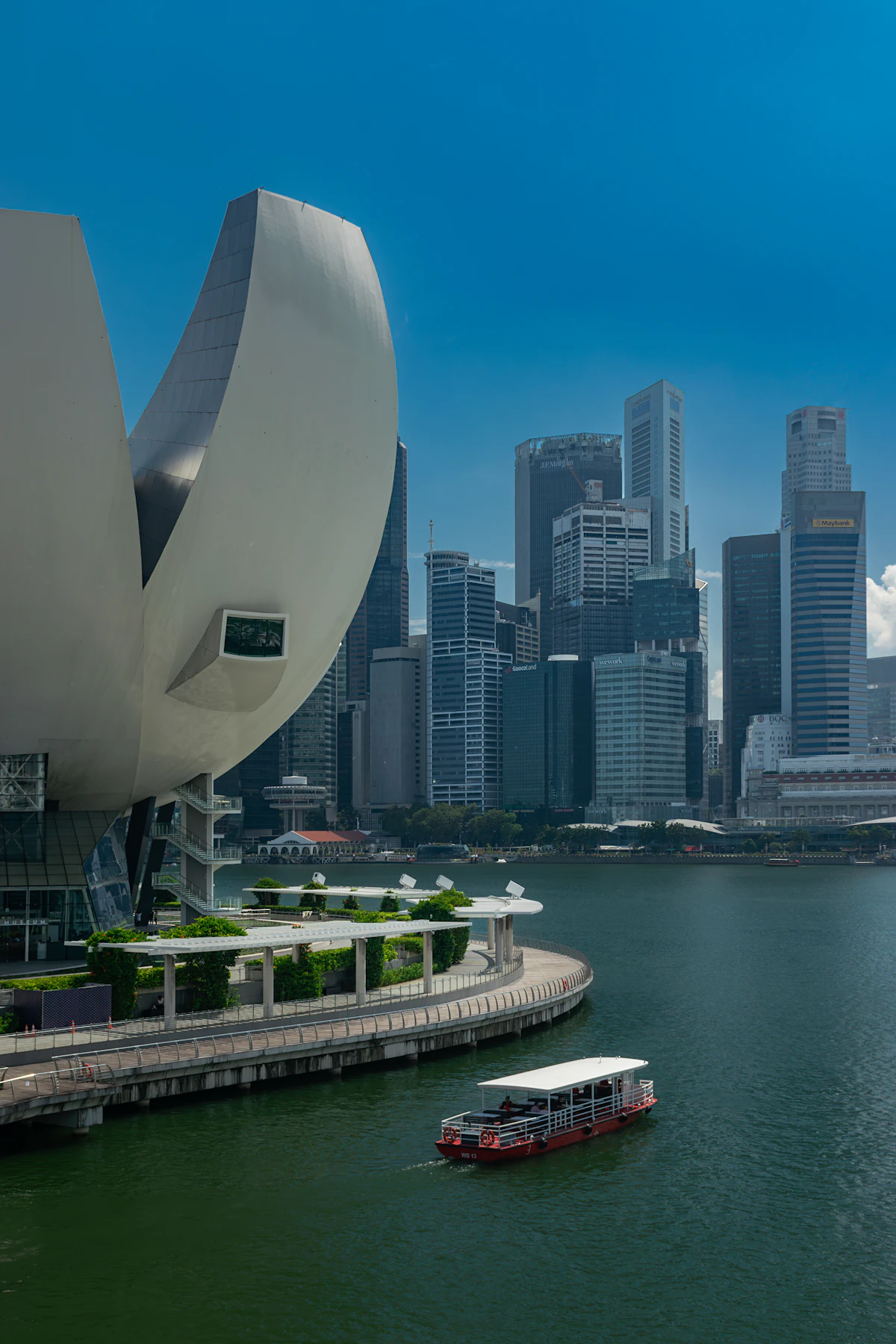 Singapore River cruise boat navigating down the scenic river towards the Marina Bay skyline
