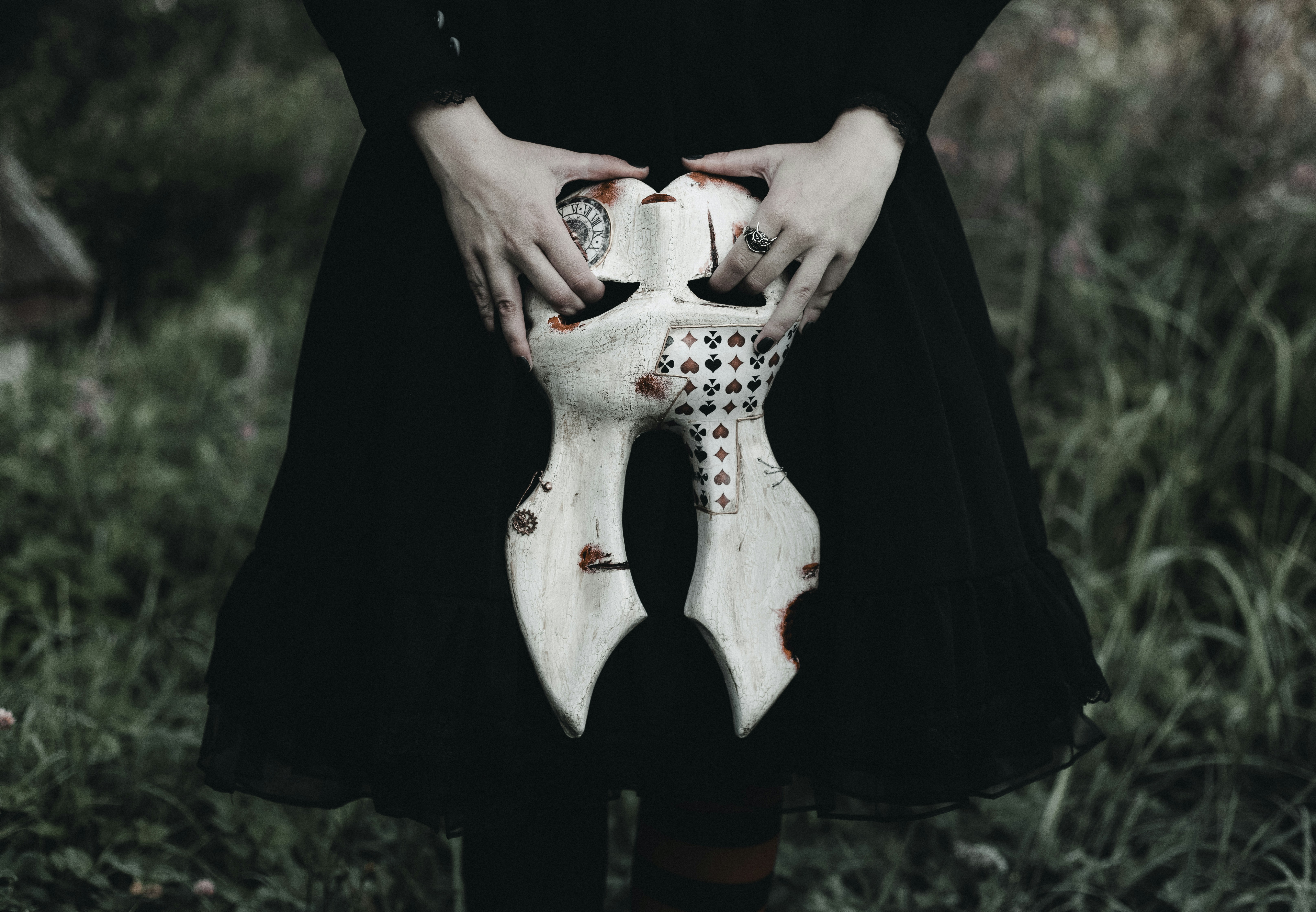 A woman in a black dress holding a white guitar
