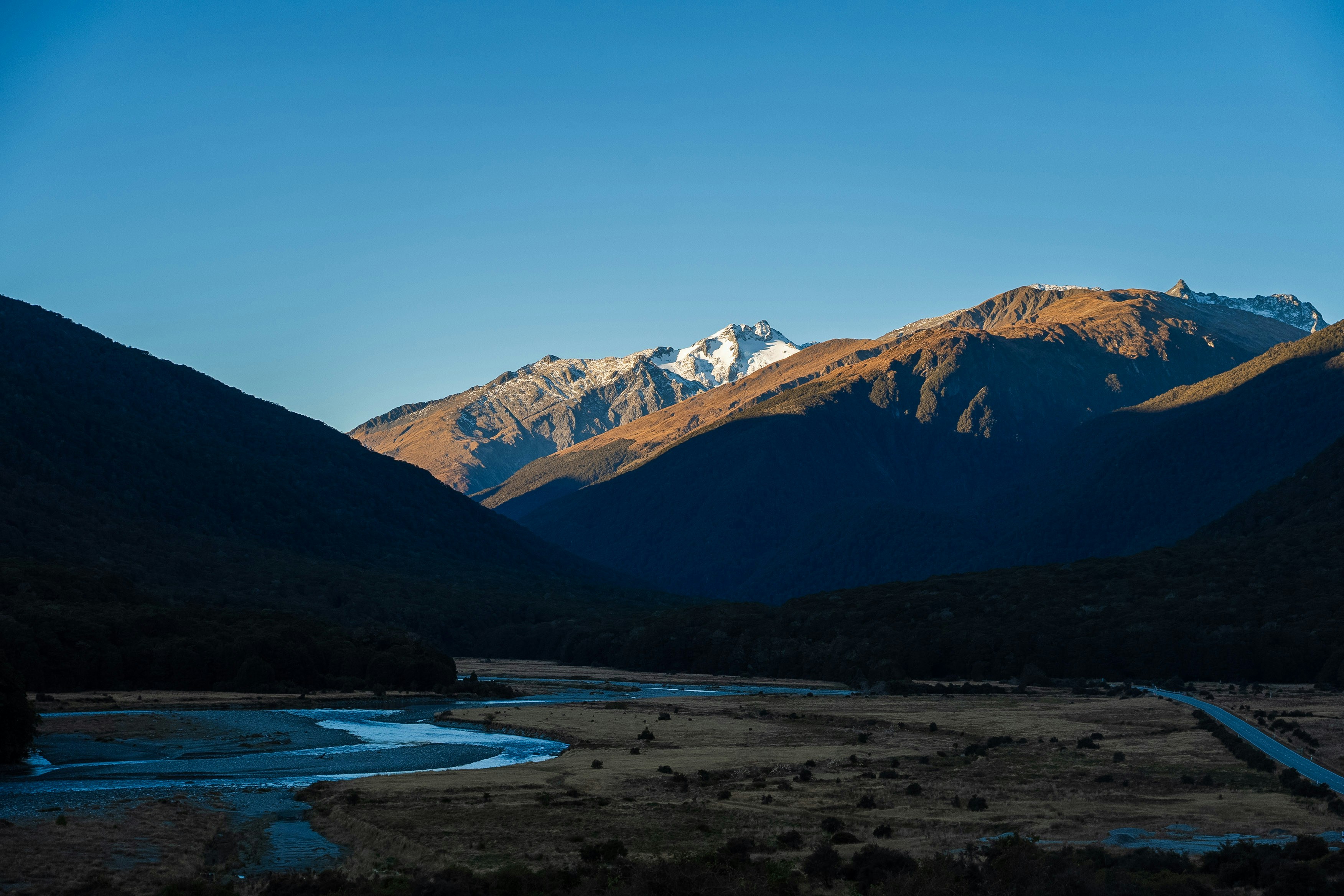 A view of a mountain range with a river in the foreground, 