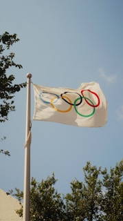 A white flag with the olympic rings on it