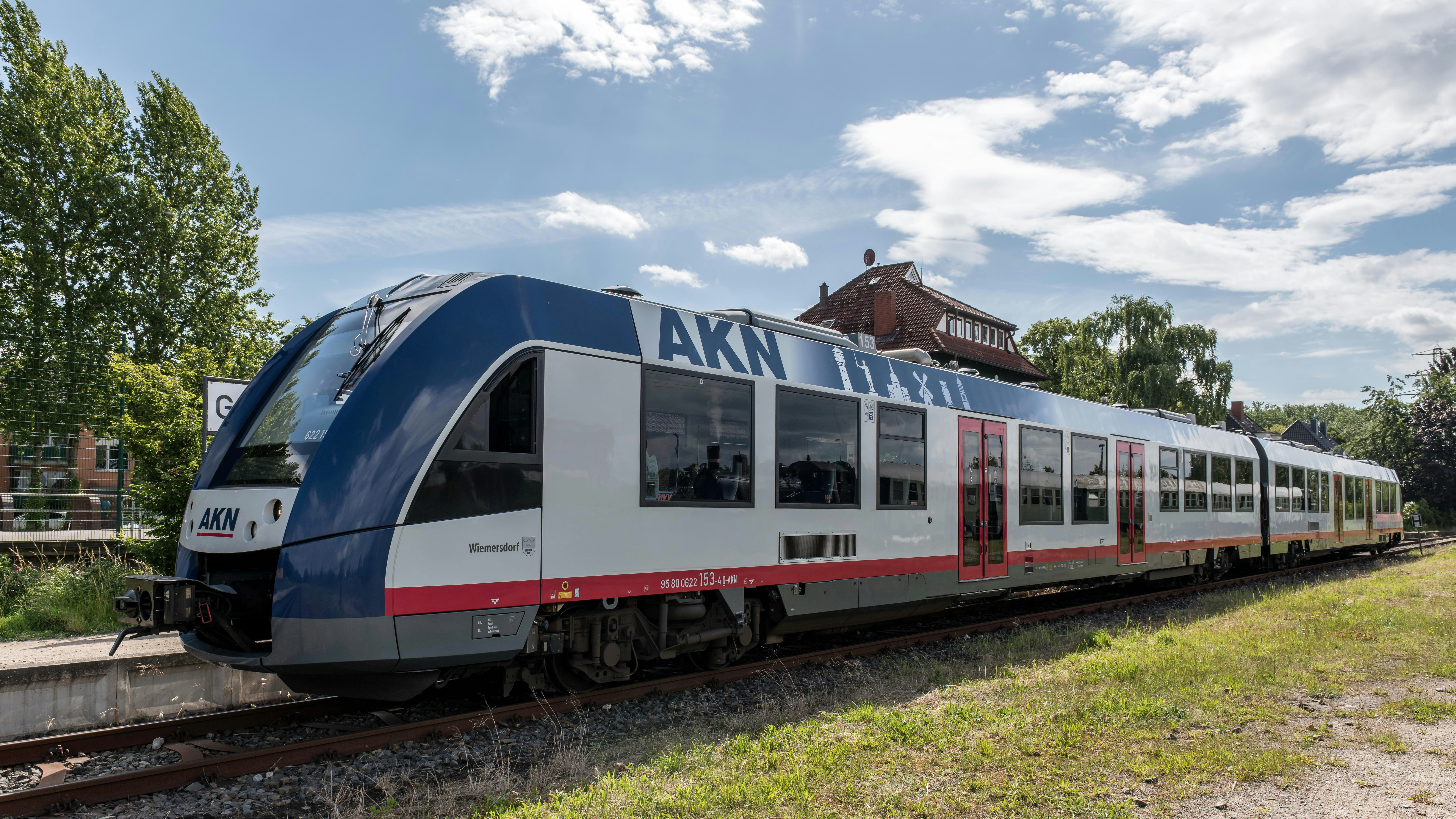 A blue and white train traveling down train tracks