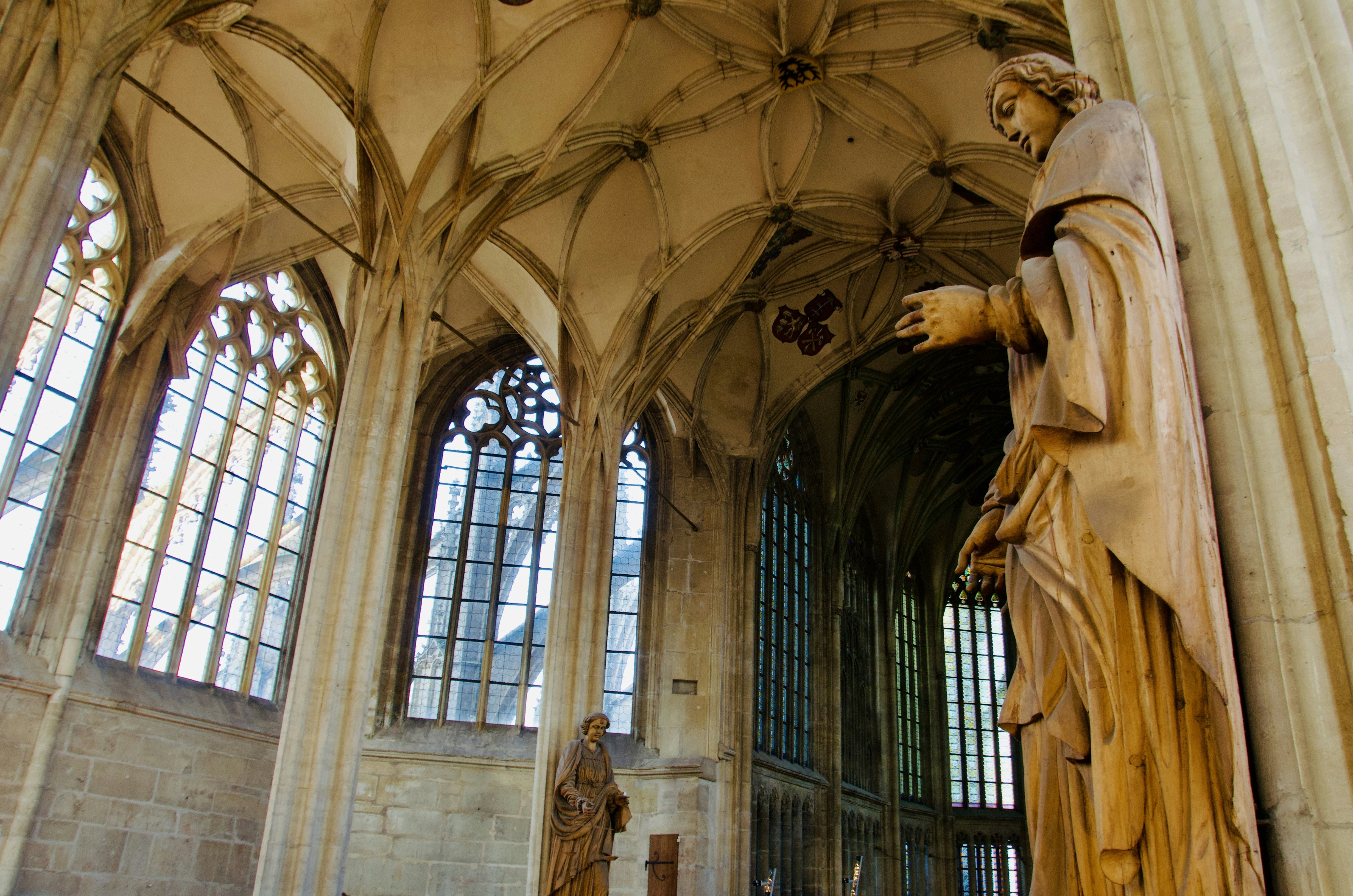 A carved religious statue located inside a historic cathedral.