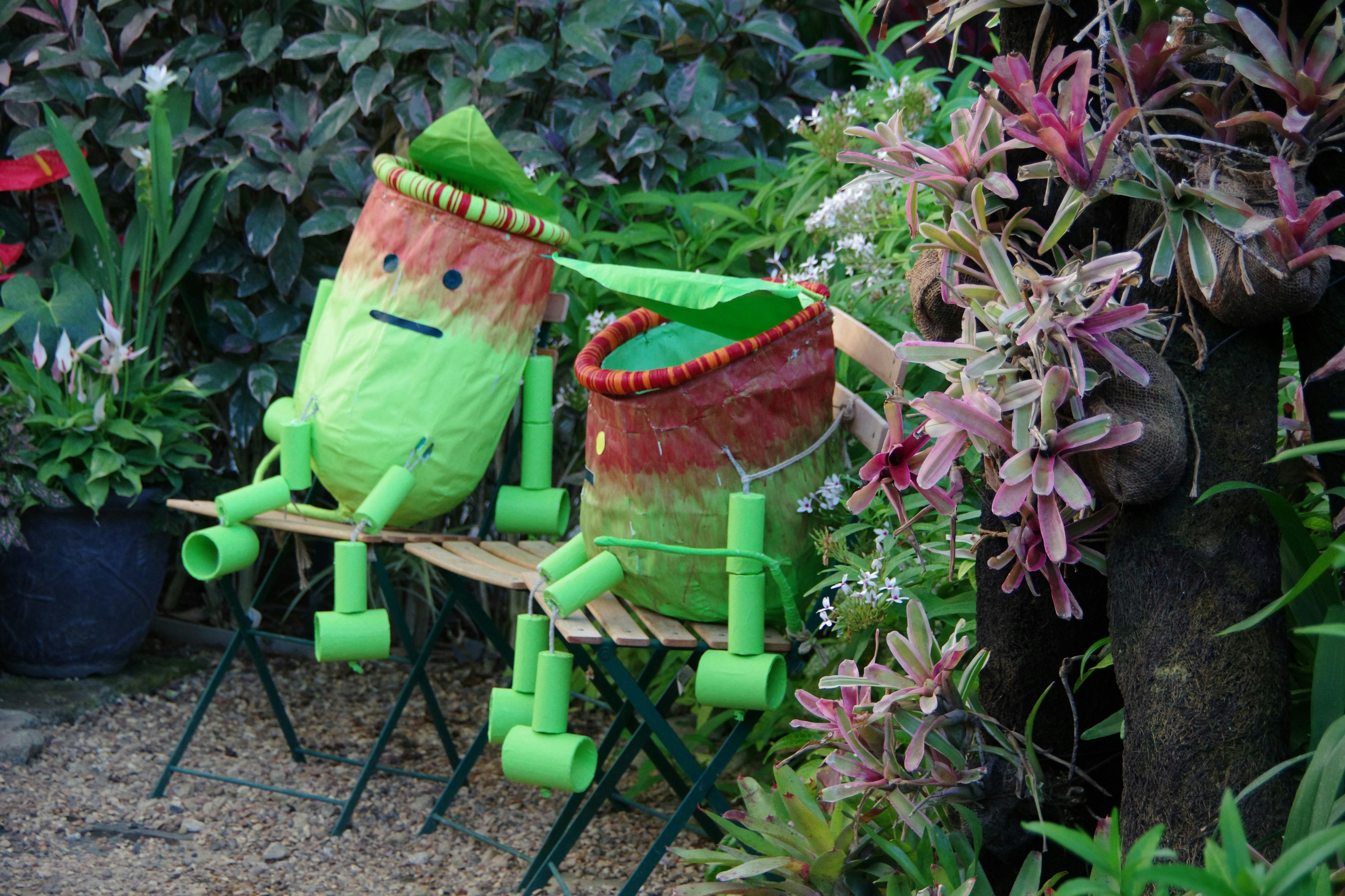 A couple of lawn chairs sitting in a garden