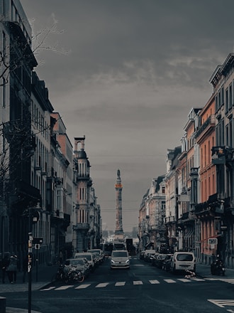 A city street with cars parked on both sides of it