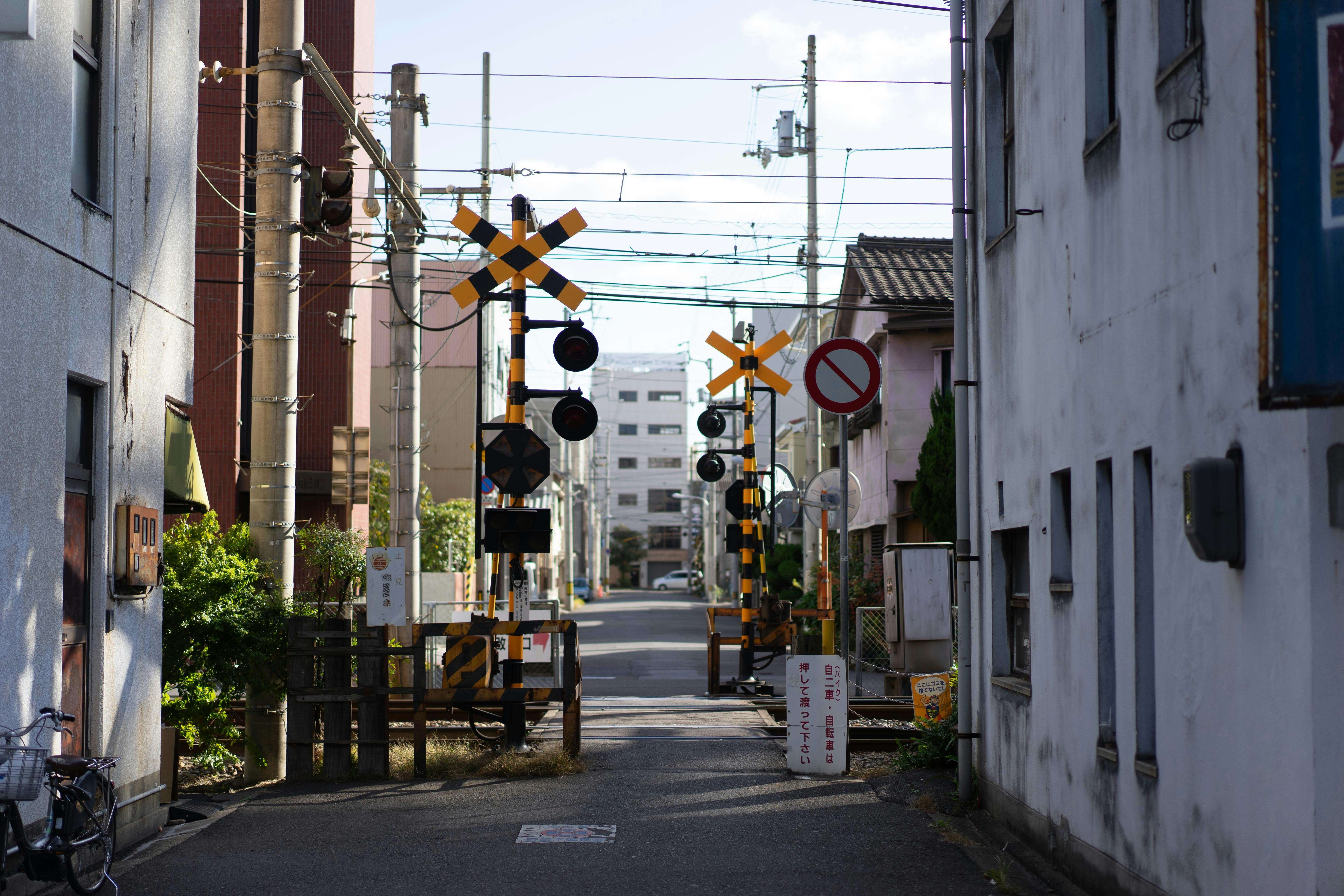 A narrow street with traffic lights and signs