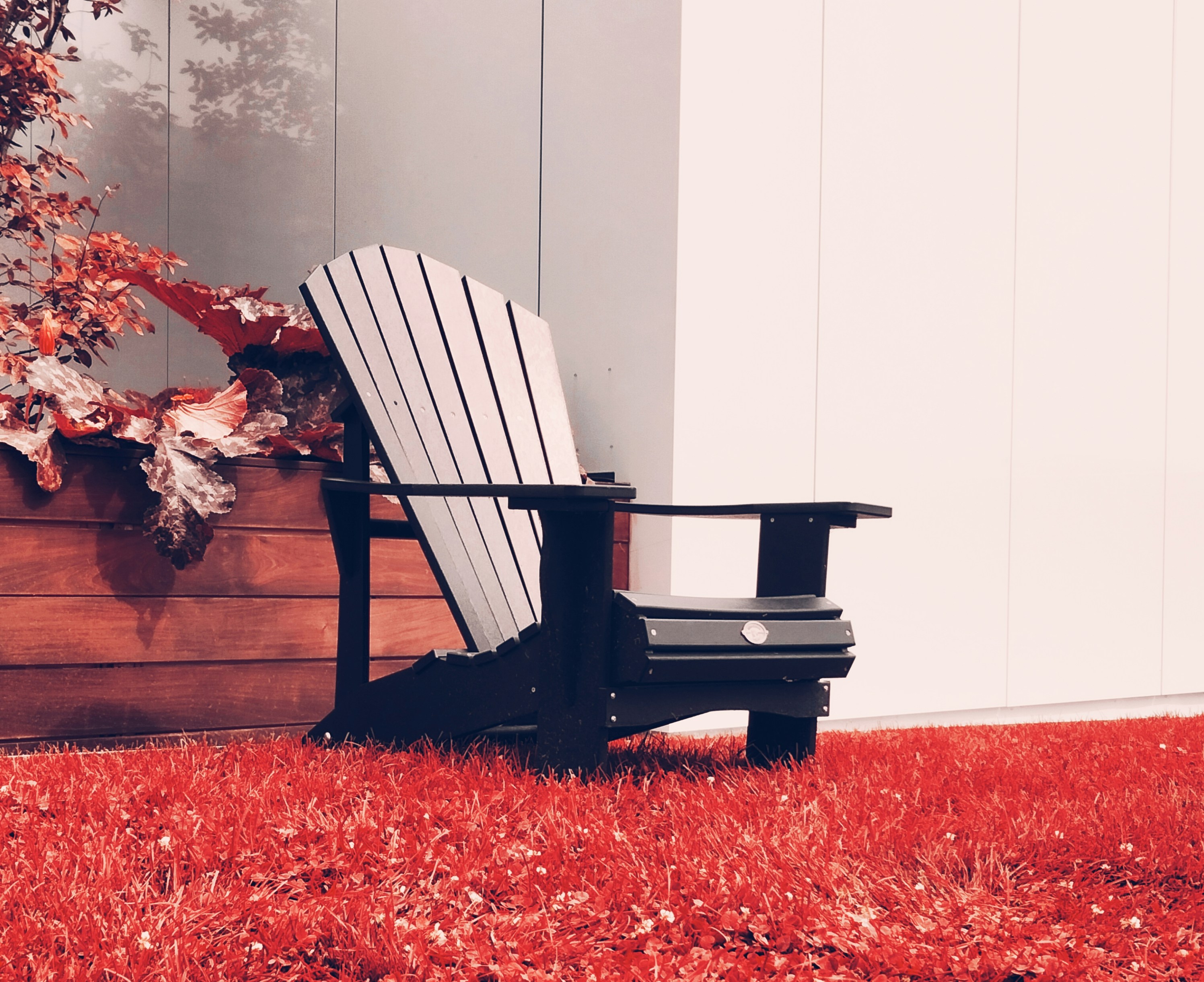 A black and white chair sitting on top of a red carpet