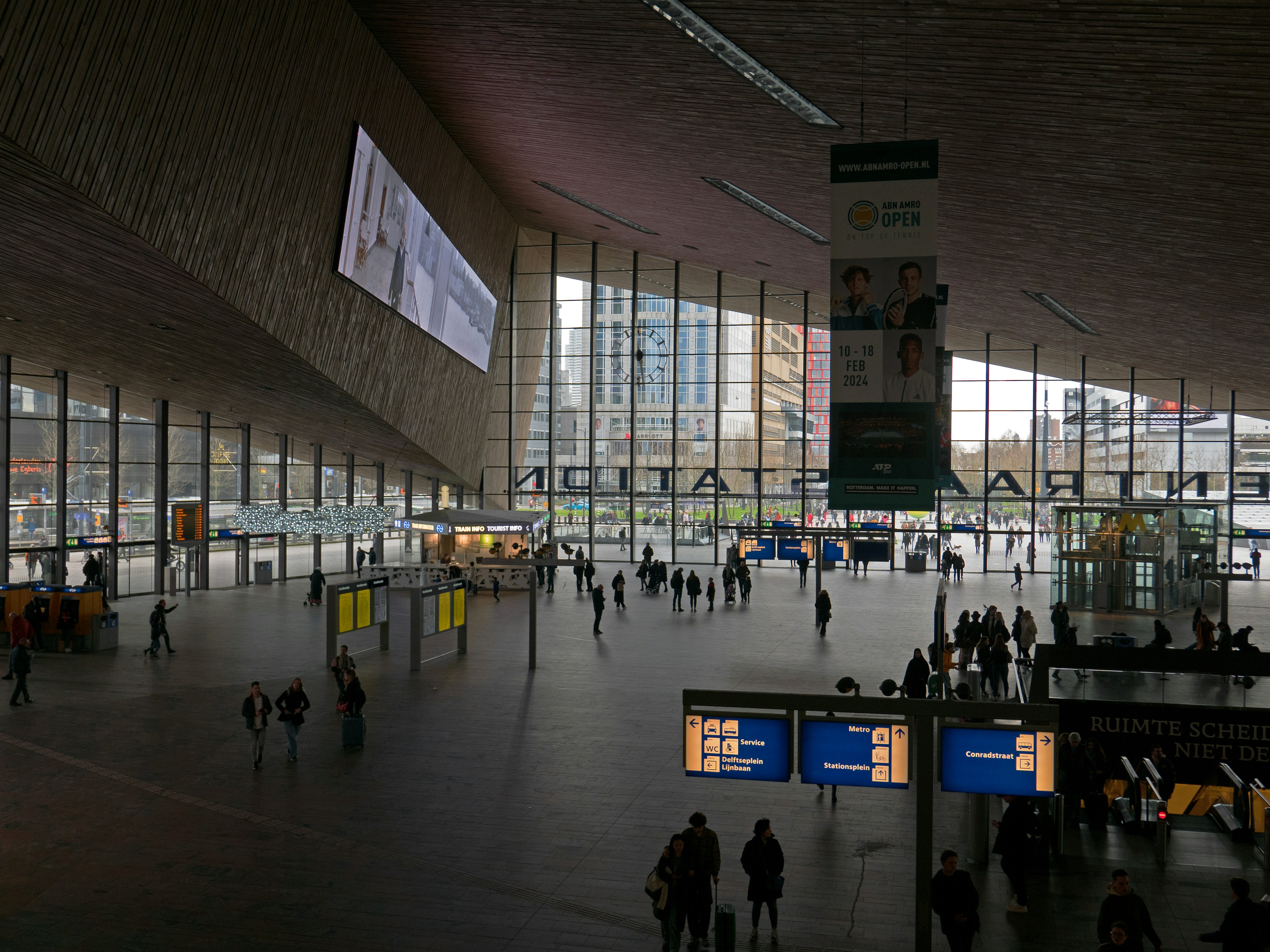 A group of people walking around a terminal
