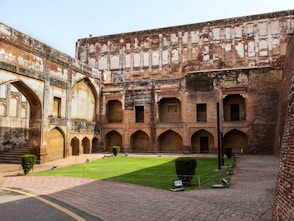 An old building with a green lawn in front of it
