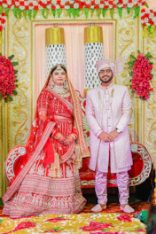 A bride and groom posing for a picture