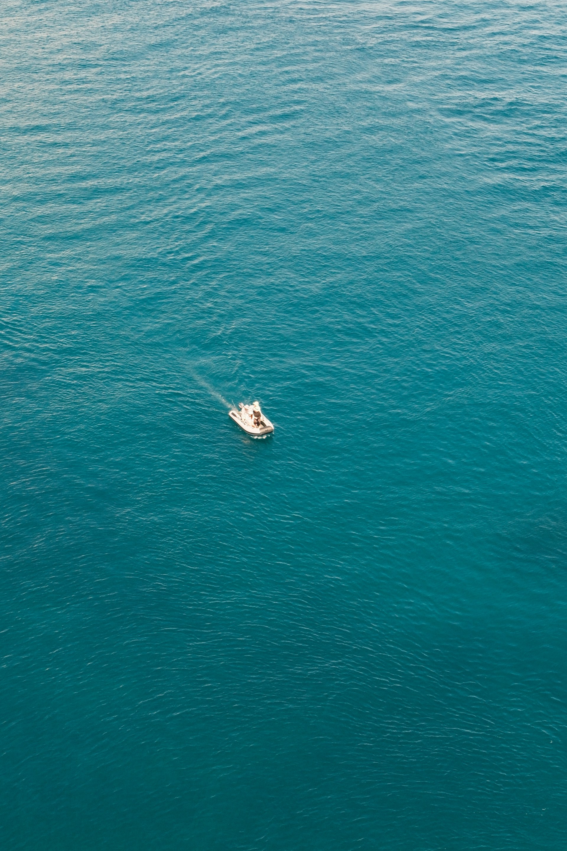 A boat floating in the middle of the ocean