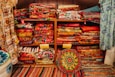 A room filled with lots of colorful fabrics and rugs