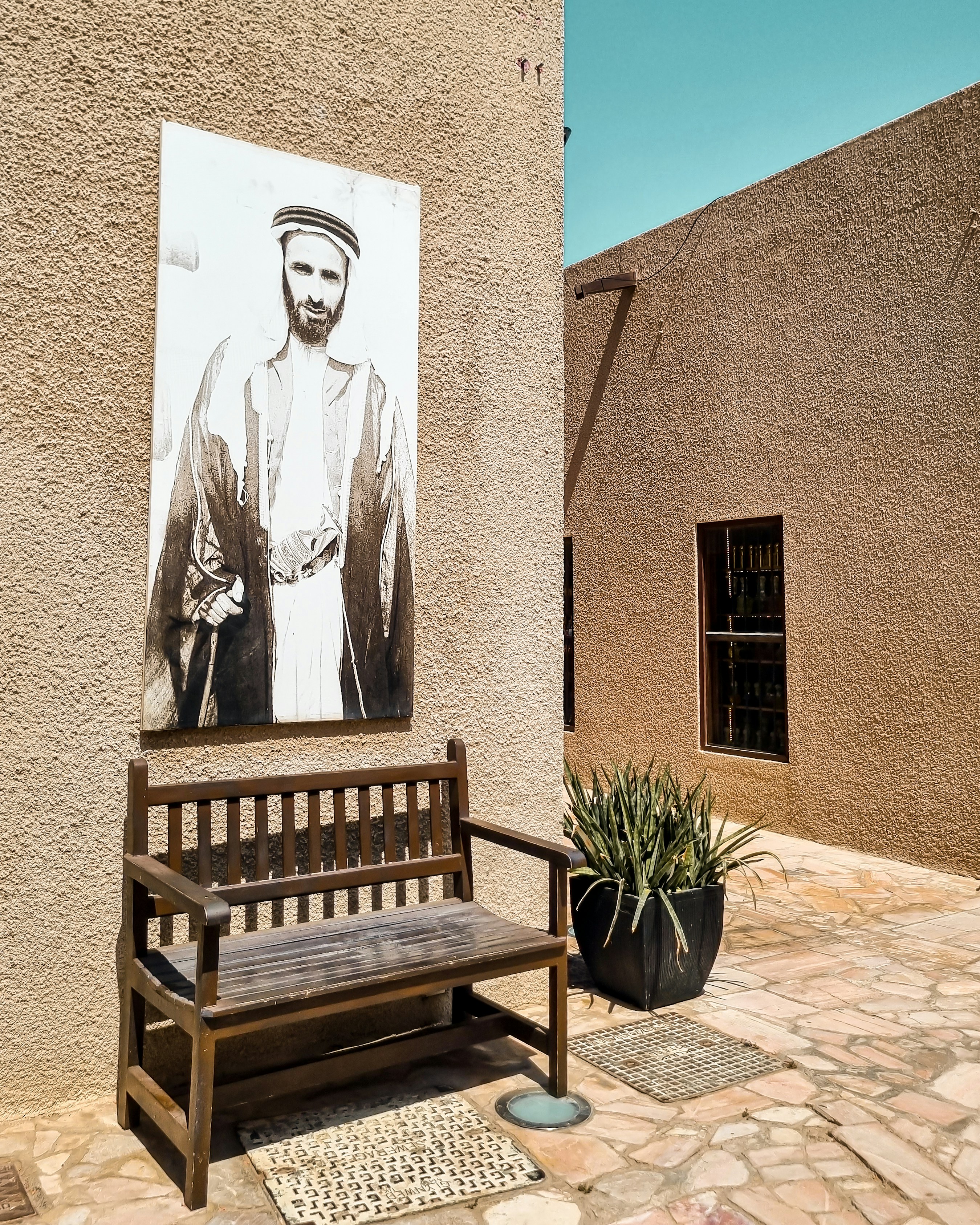 A wooden bench sitting in front of a building