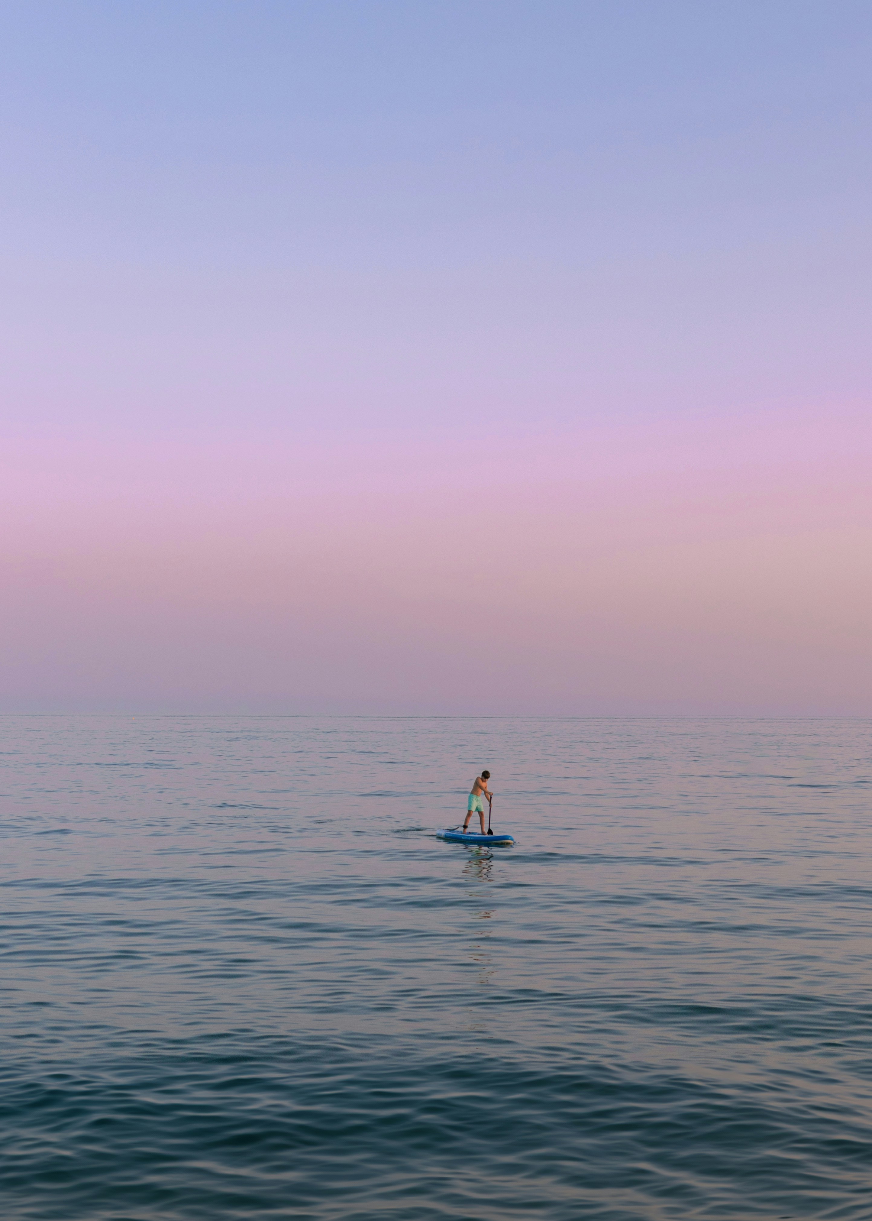 A person on a surfboard in the middle of the ocean