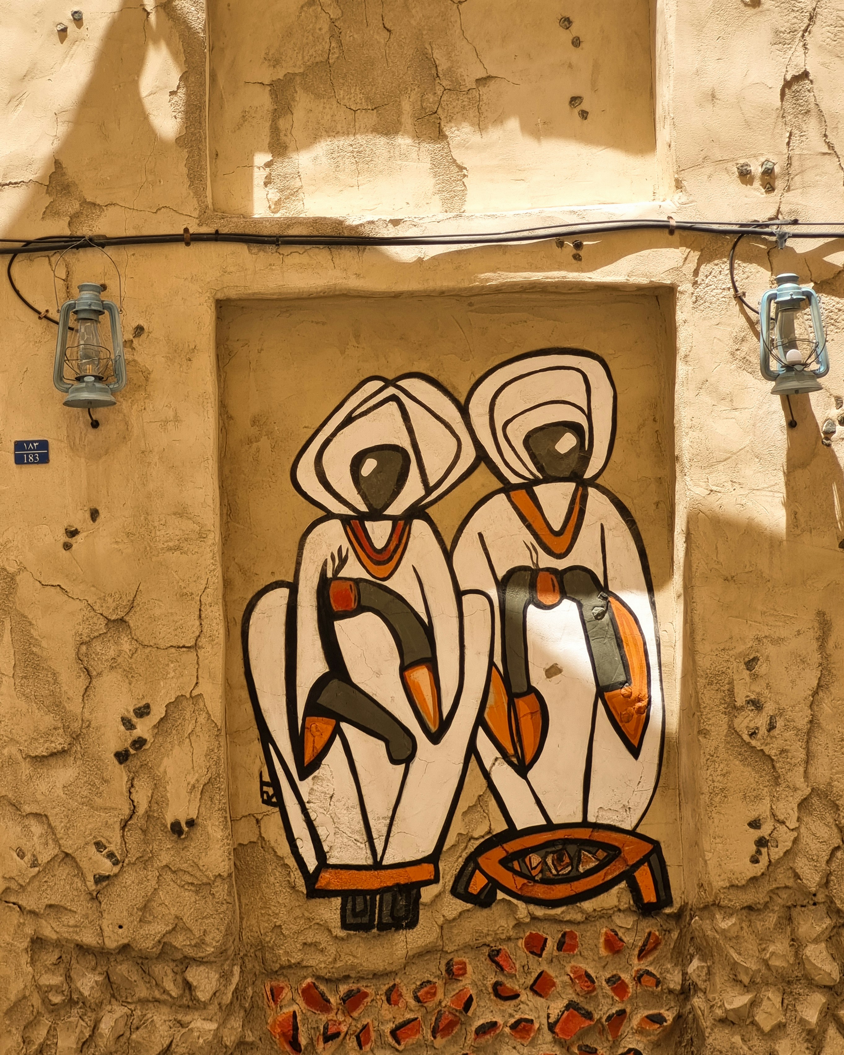 A picture of two birds painted on the side of a building