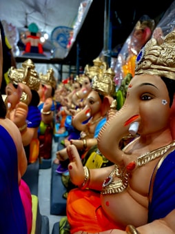 A group of statues of hindu deities sitting on a bus