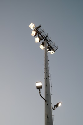 A tall light pole with a bunch of lights on top of it