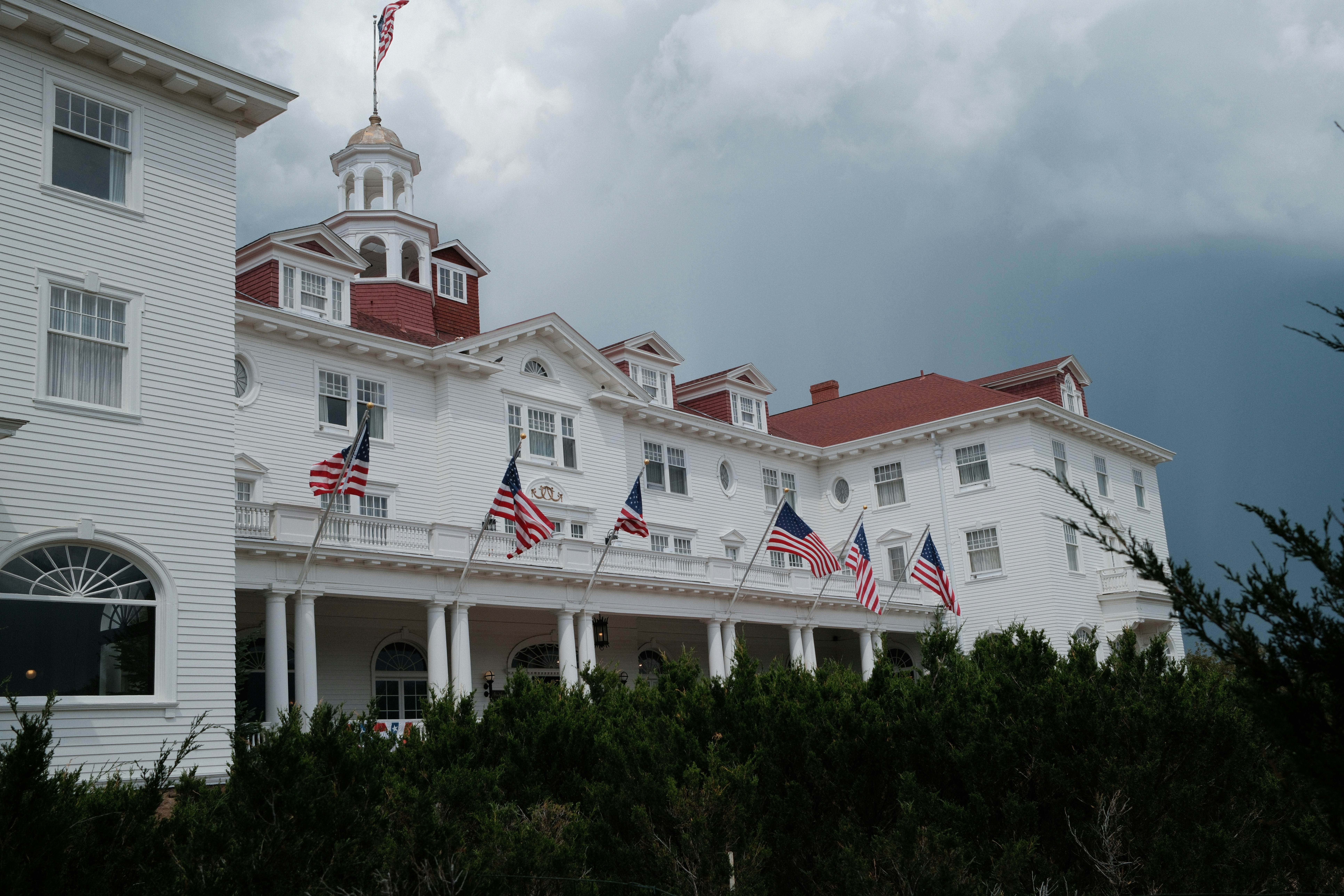 A large white building with a red roof