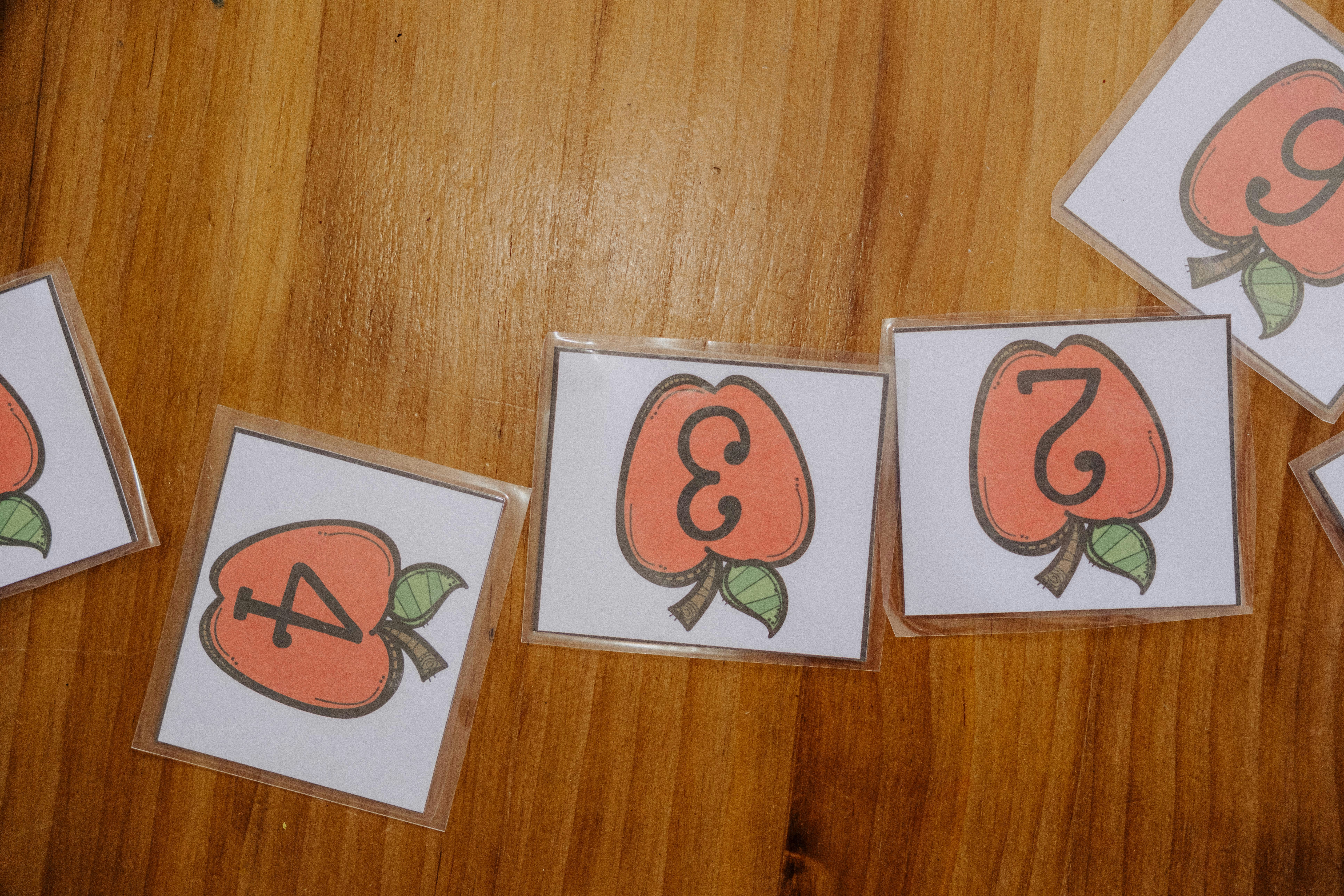 A wooden table topped with lots of cards