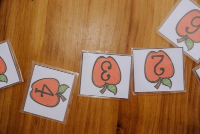 A wooden table topped with lots of cards